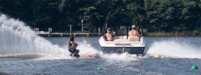 Image of a waterskier behind a ski boat on a slaloam course