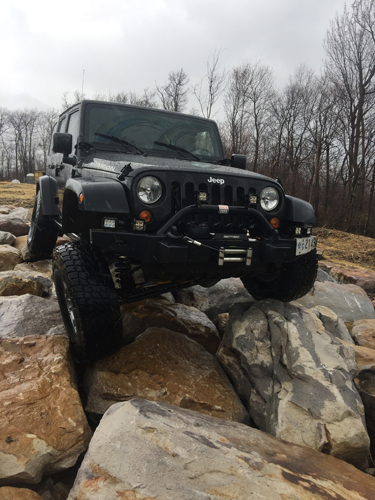 A jeep sitting on rocks.