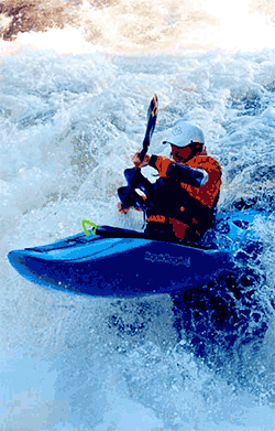 Kayaker in white water with helmet on