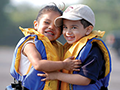 2 young children wearing life jackets